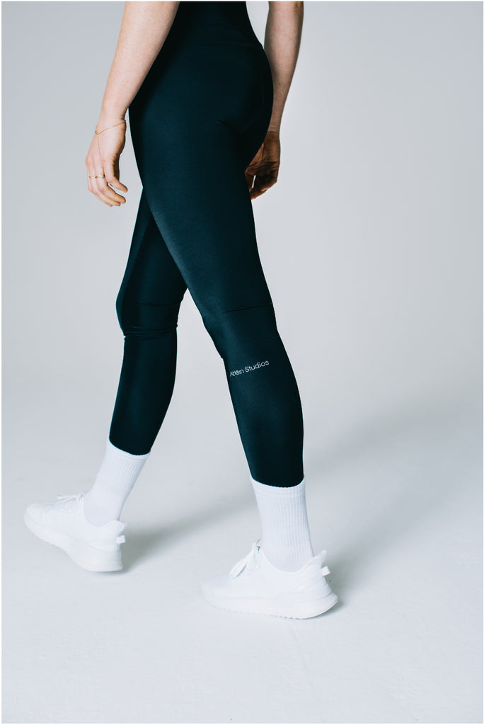 Attain Studios - Detail of black sportswear leggings made out of Econyl ® silky-touch fabric. Size S